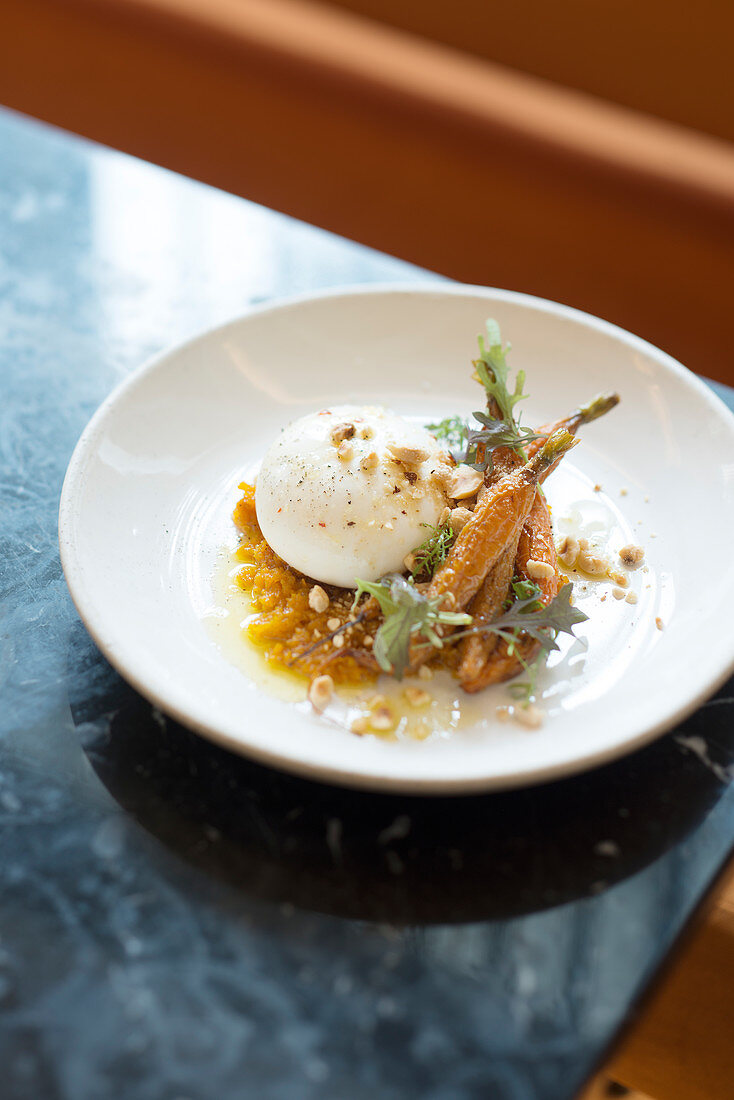 Soft-boiled egg, onion confit with squash, carrots with hazelnut sauce