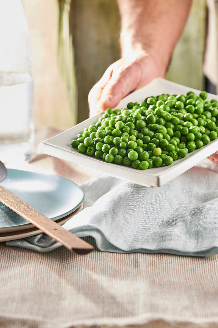 Peas as a vegetable garnish on a serving plate