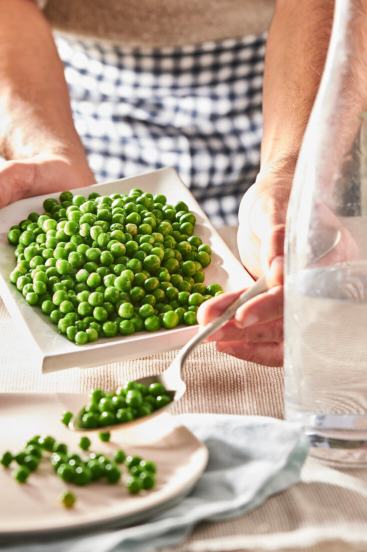 Woman serving peas