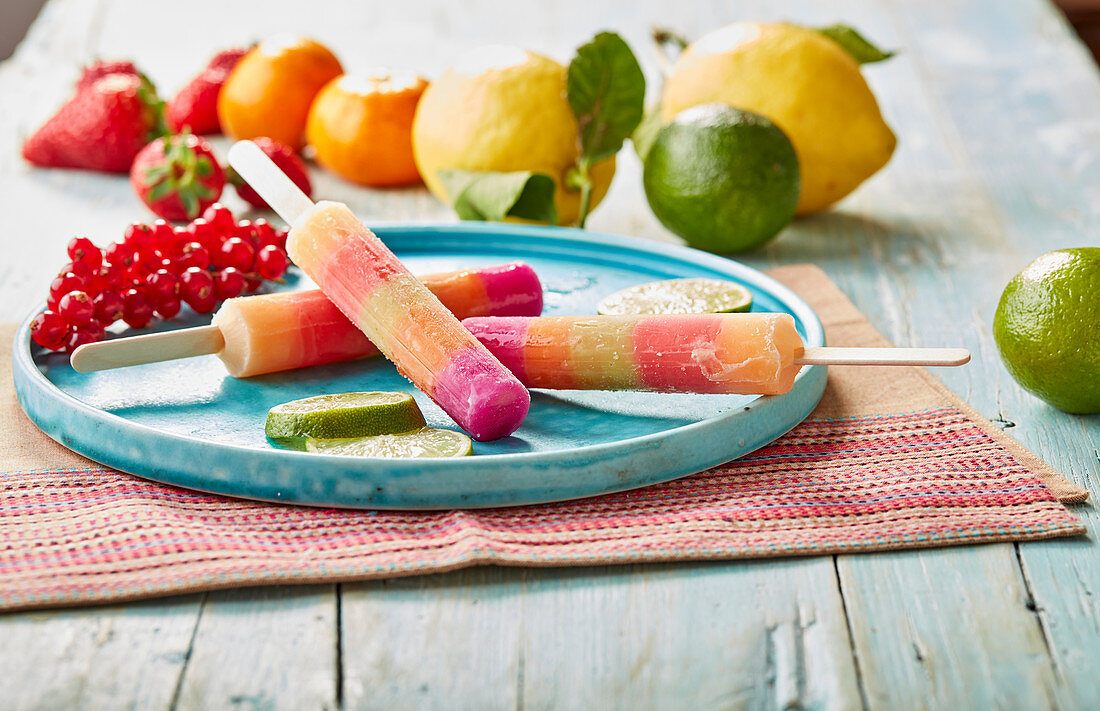 Multi-layer colourful fruit ice lollies on sticks