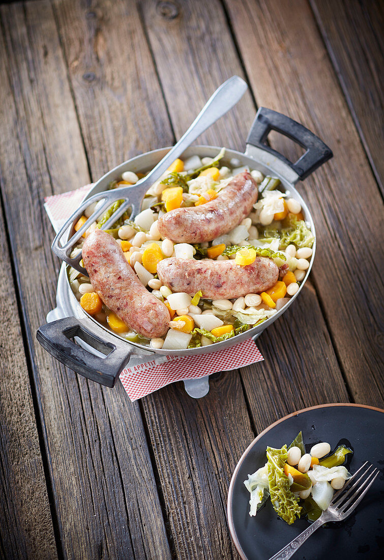 Pork sausages on vegetables