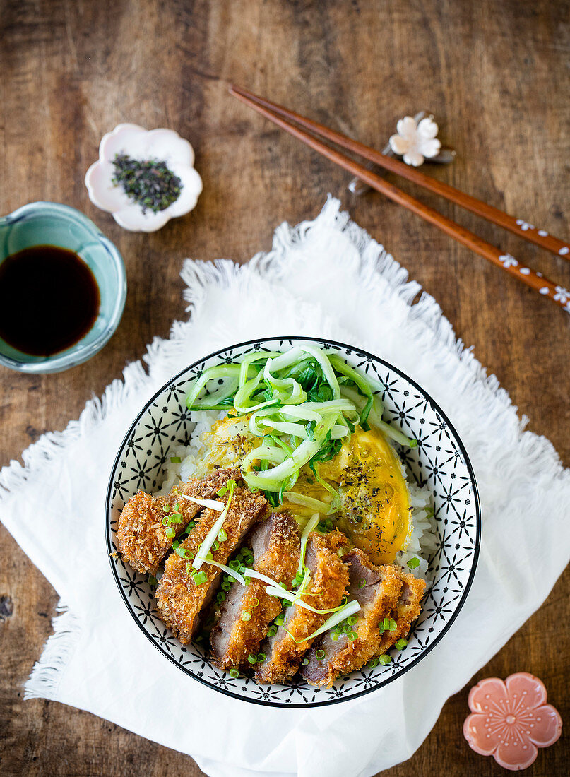 Katsudon: breaded cutlets and an onion omelette on a bowl of rice