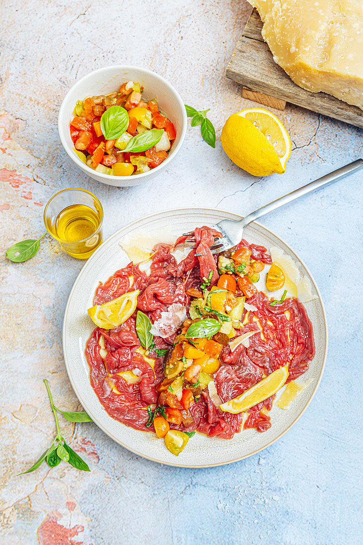 Beef carpaccio with tomato,lemon and olive oil salsa