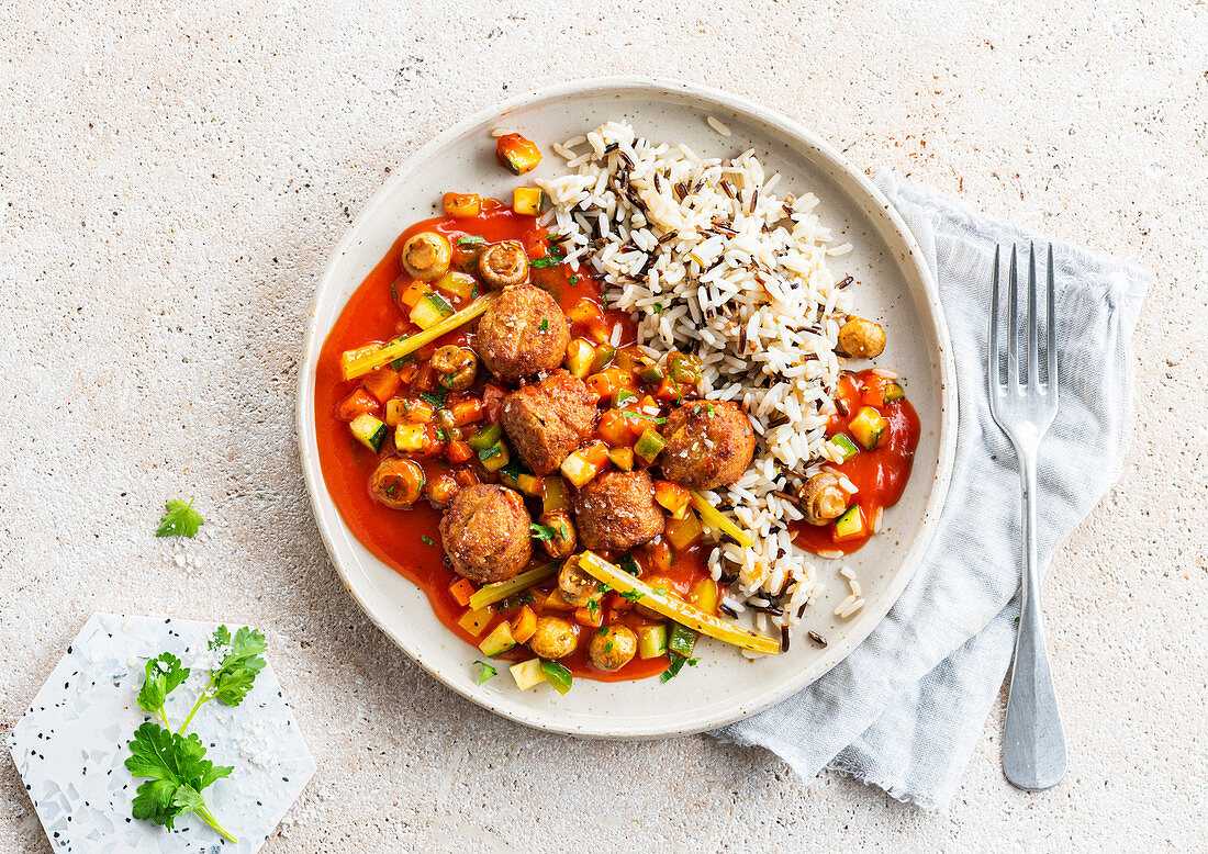 Veggie meatballs with tomato sauce, vegetables and rice