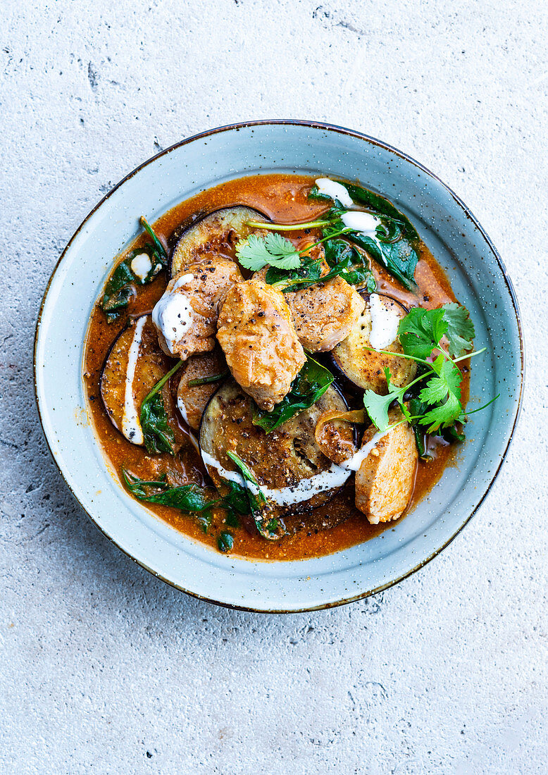 Pork in eggplant, spinach and tomato sauce