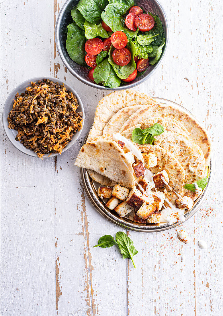Cheese naans, lentil salad with carrots and spinach cherry tomatoes