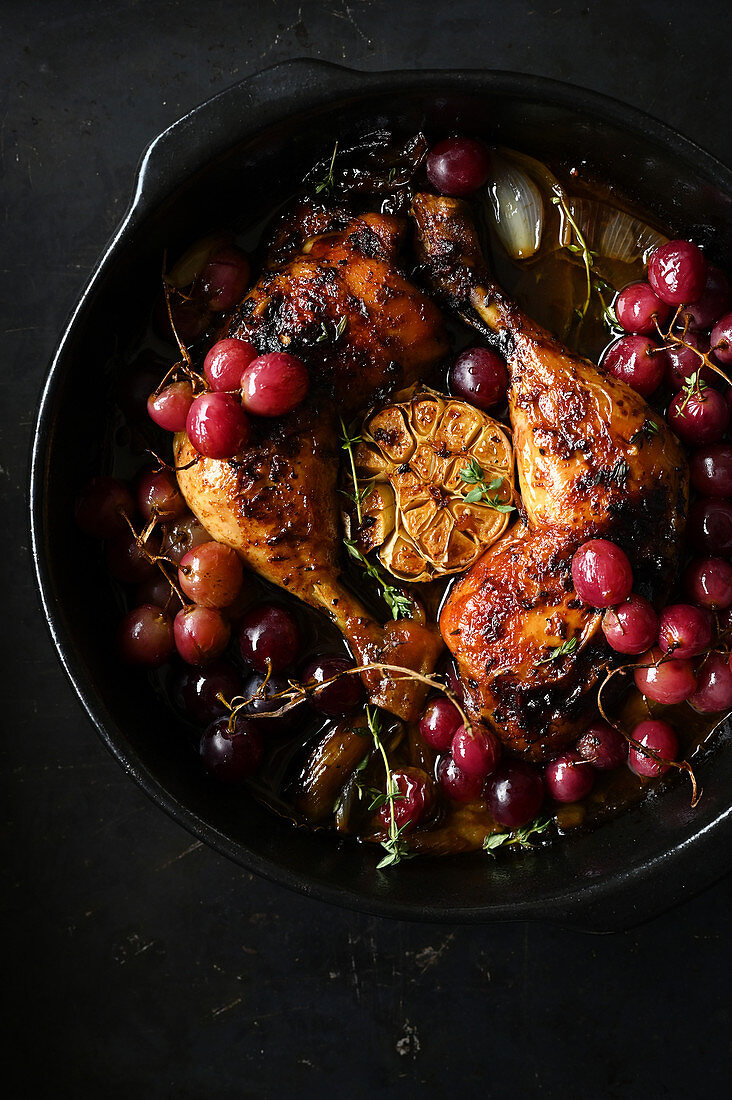 Roasted chicken legs with black grapes