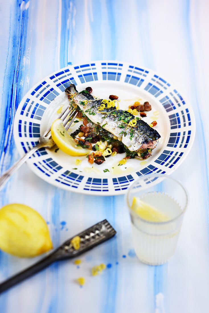 Roasted mackerel with herbs,onions,raisins and pine nuts