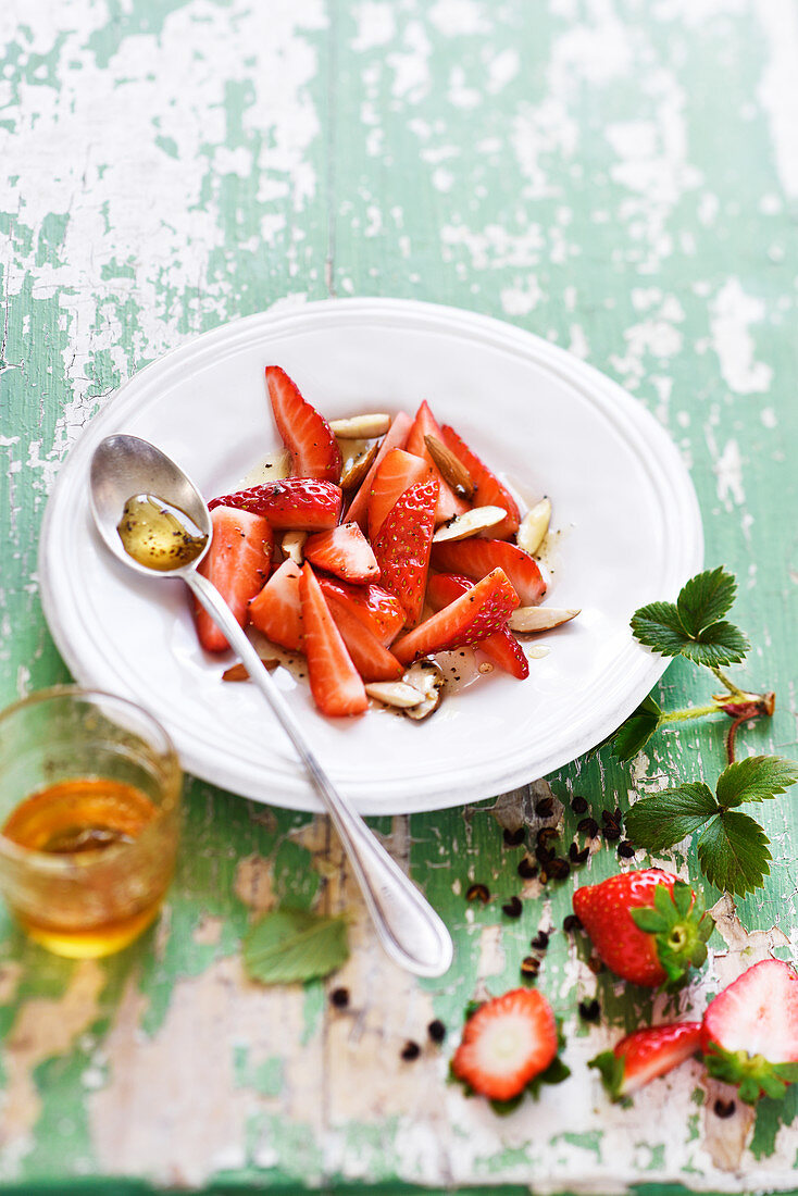 Strawberry fruit salad with almonds,honey and Timut pepper syrup