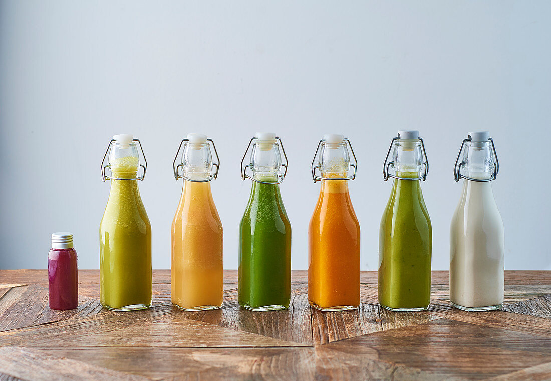 Assorted bottles of detox juice with fruits and vegetables