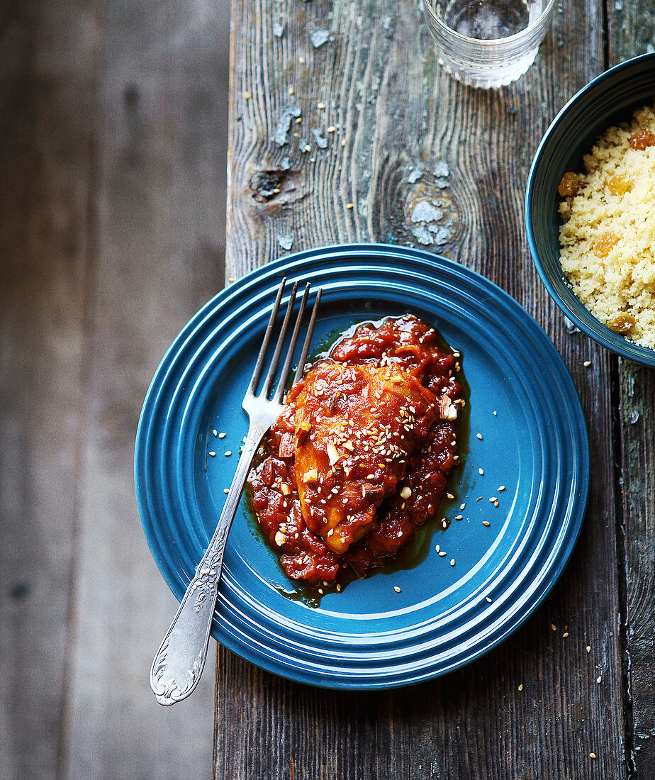 Chicken in honey and tomato sauce with semolina and grapes