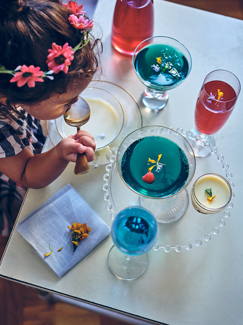 Little girl playing with coloured jellys on a table
