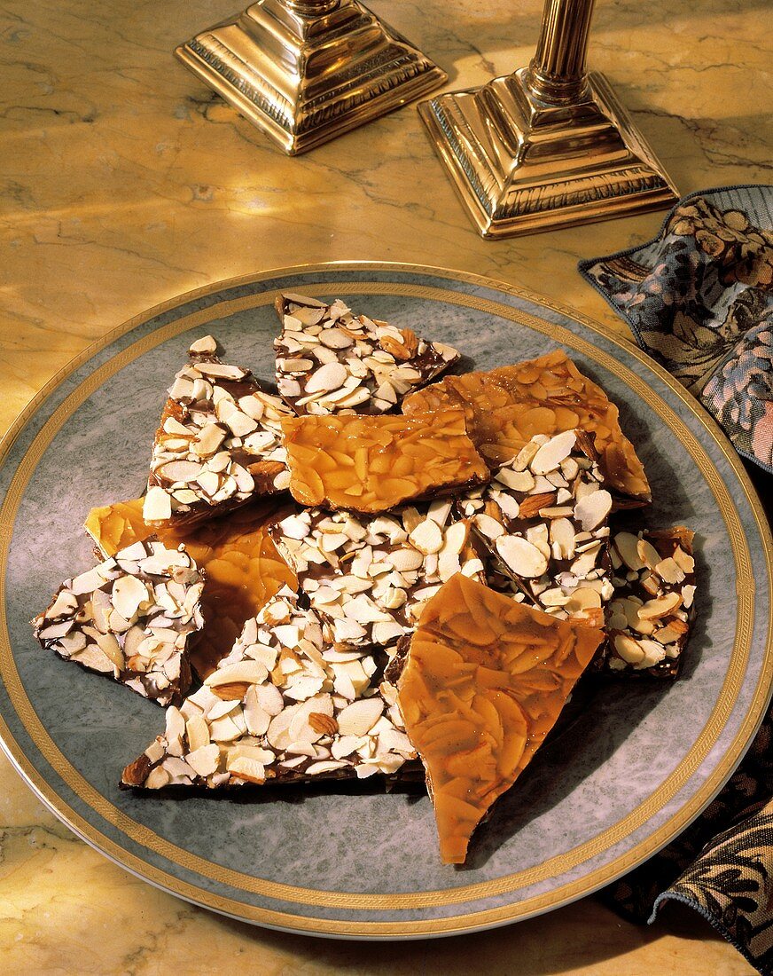 Mandelkrokant mit Schokolade & Honig, in Stücken auf Teller
