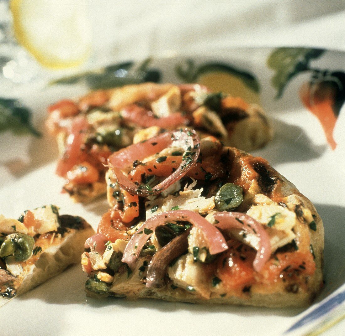 Grilled pizza with smoked salmon, capers, red onions & roasted red peppers