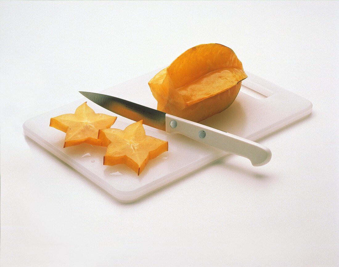 Carambola on a Cutting Board Being Sliced