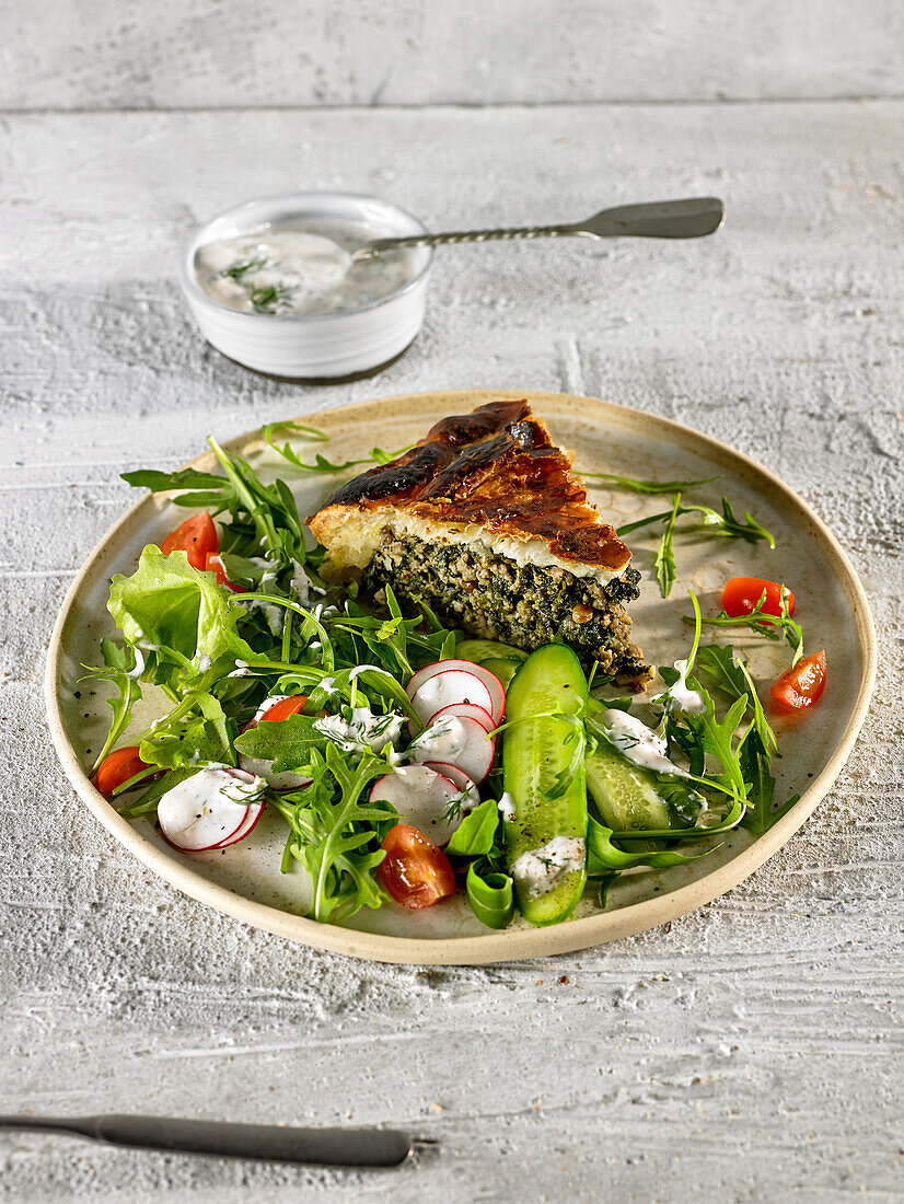 Spinach and meat tart with salad garnish