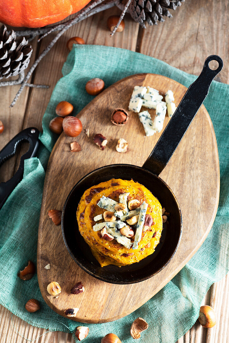 Squash blinis with hazelnuts and blue cheese