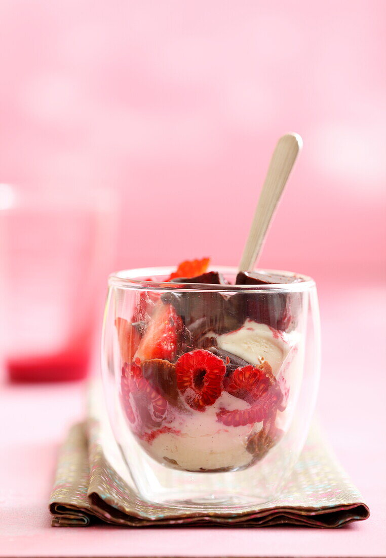 Sundae with vanilla ice cream, chocolate ice cream and fresh raspberries