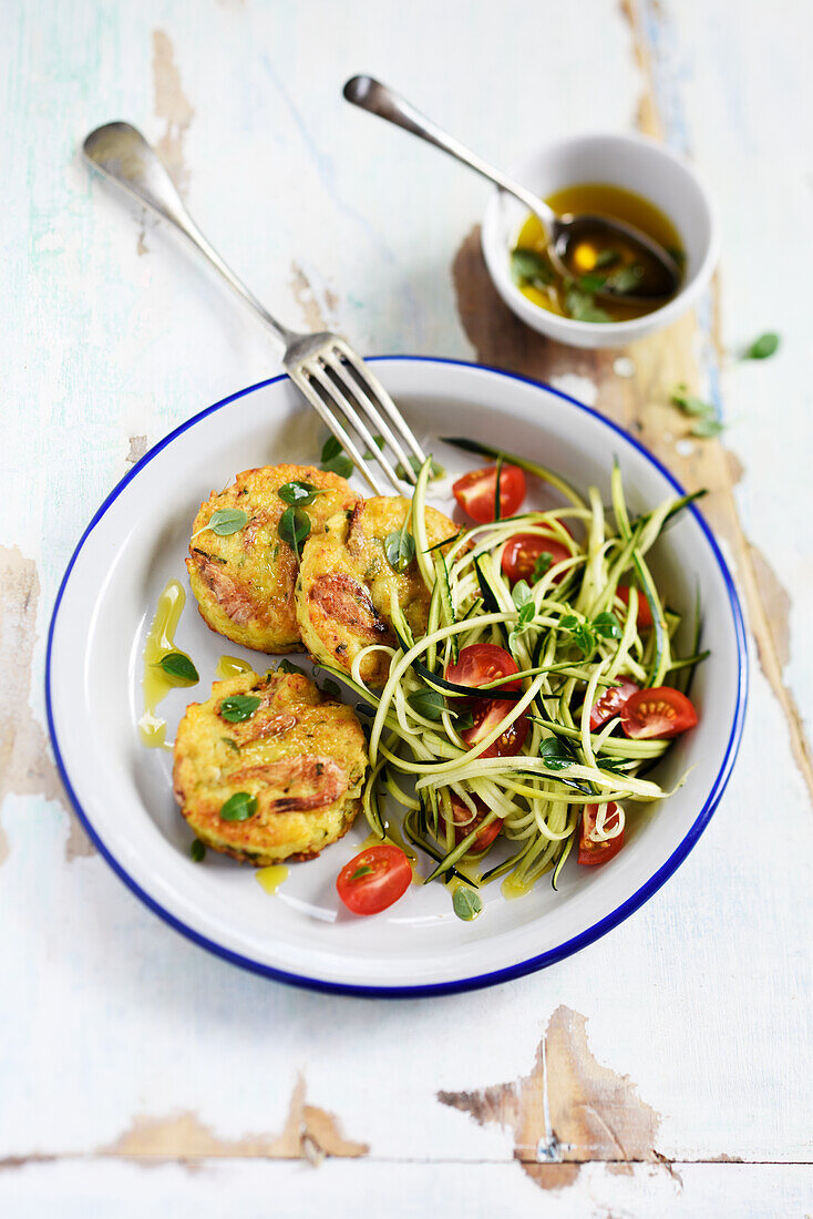 Potato, clam, and shrimp cakes served with zucchini salad with tomatoes