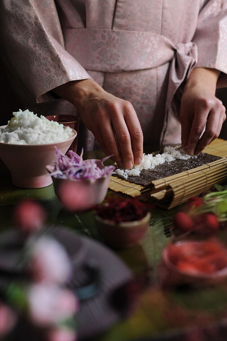 Woman making maki sushi