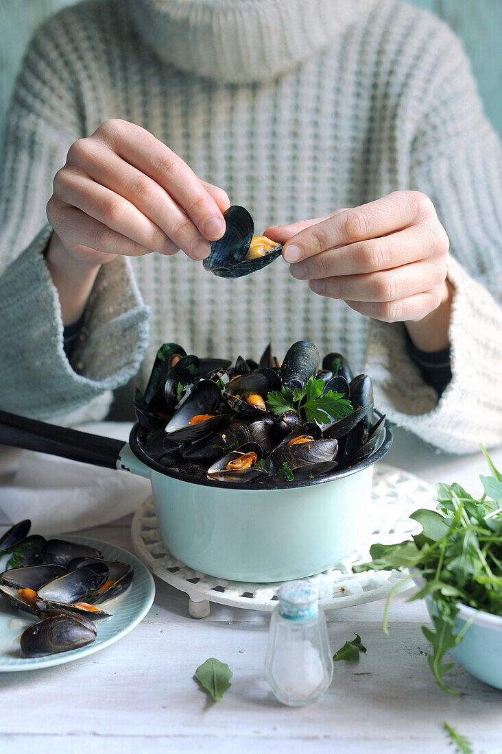 Woman eating marinated mussels