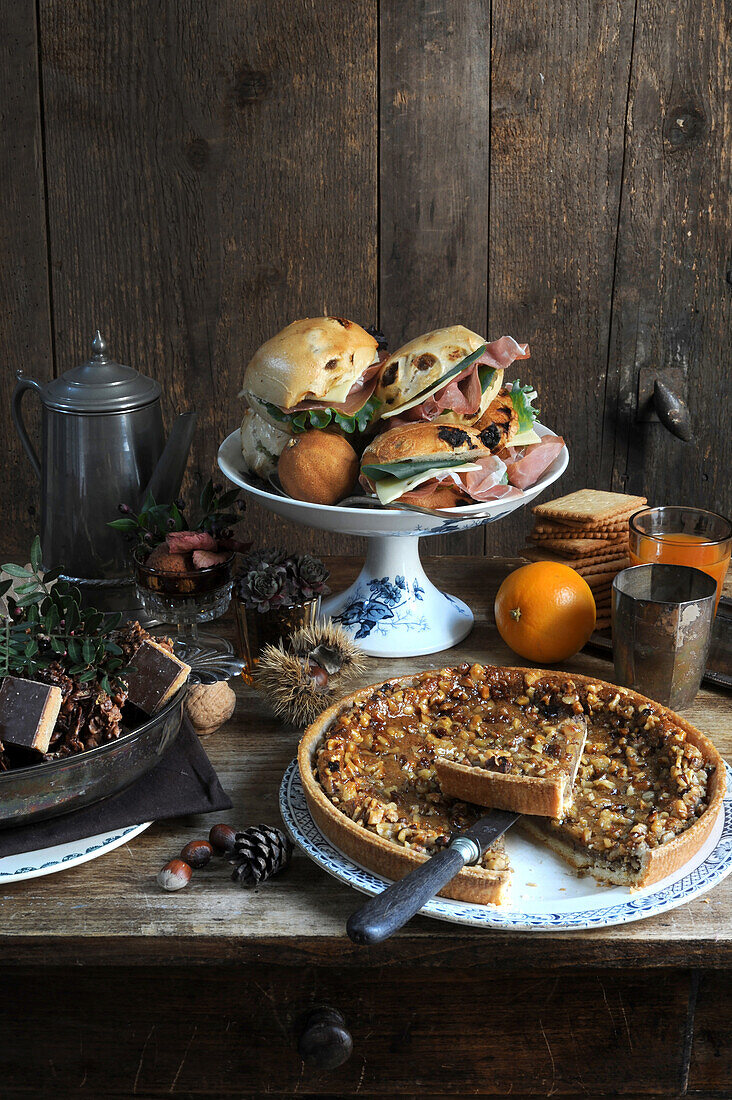 Autumn brunch buffet with sandwiches, orange juice, and pecan pie