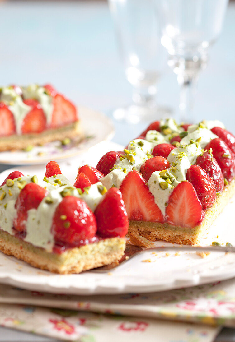 Cake with shortbread crust topped with strawberries and pistachios