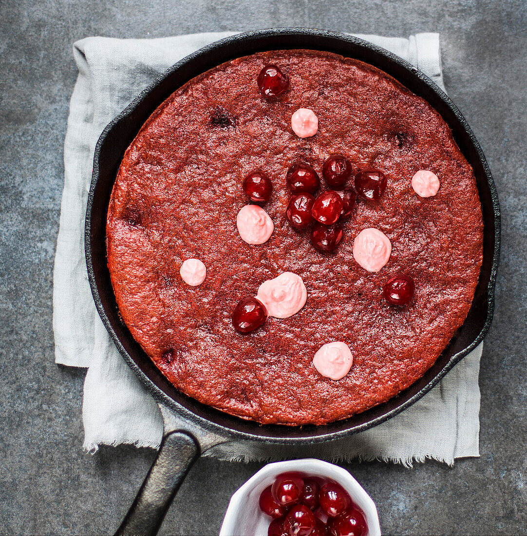 Cake with candied cherries baked in a cast iron pan