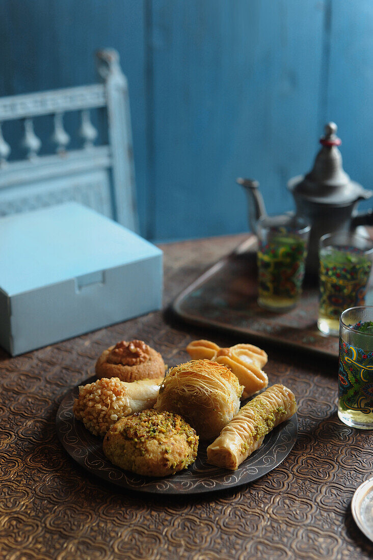 Moroccan pastries on a plate with mint tea