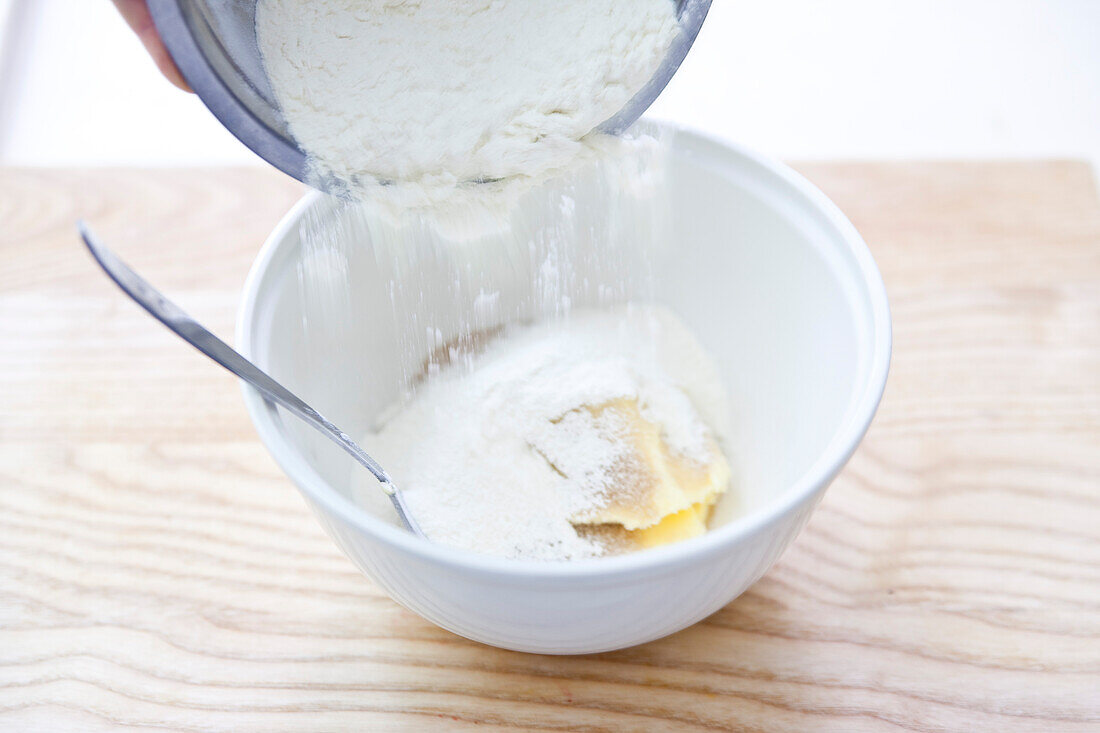 Making apricot crumble: For the crumble, add flour to the butter