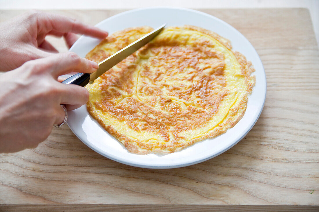 Cutting an omelette