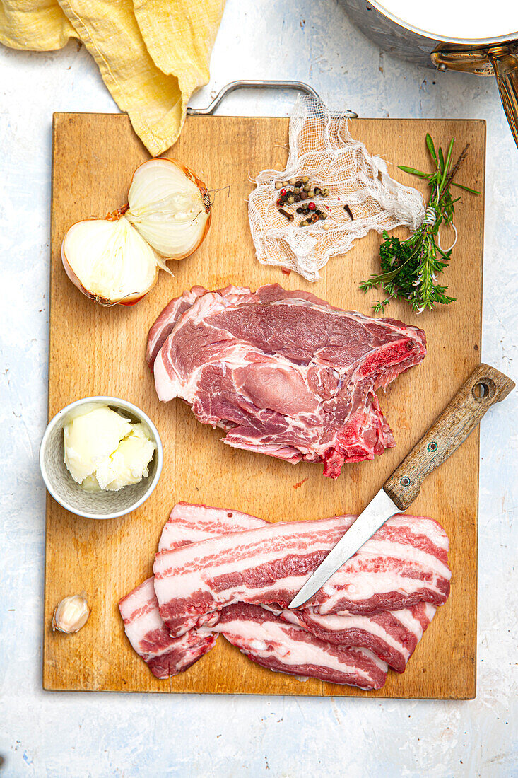 Ingredients for traditional rillettes on a wooden cutting board