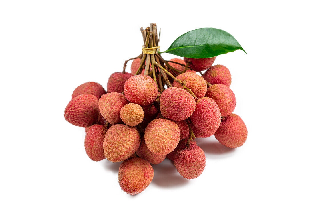 Lychees bunched up against a white background