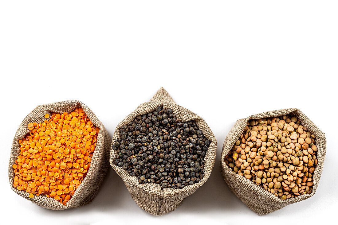 Three types of lentils against white background