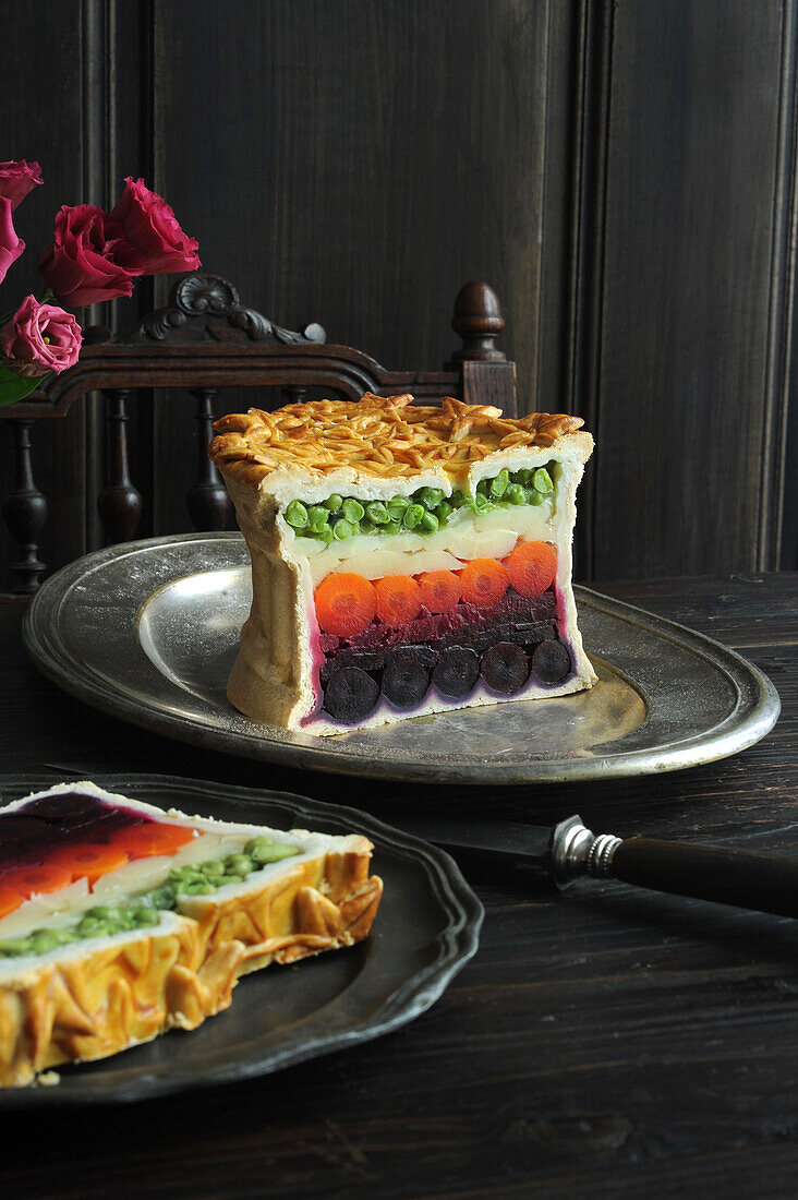 Vegetarian pâté wrapped in pastry with rainbow colored vegetable layers