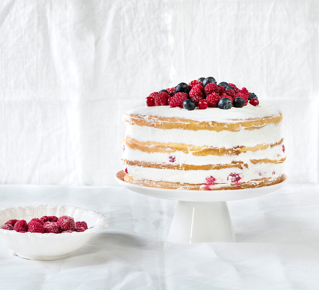 Layer cake decorated with red fruits
