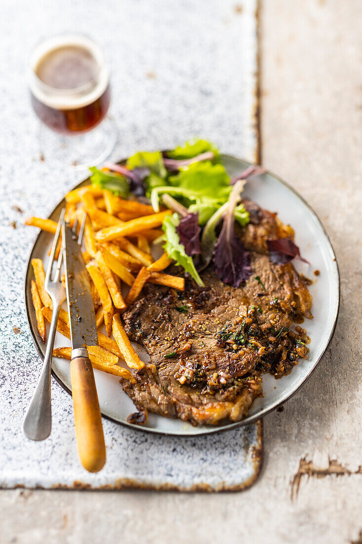 Grilled beef marinated in beer, fries, brown beer