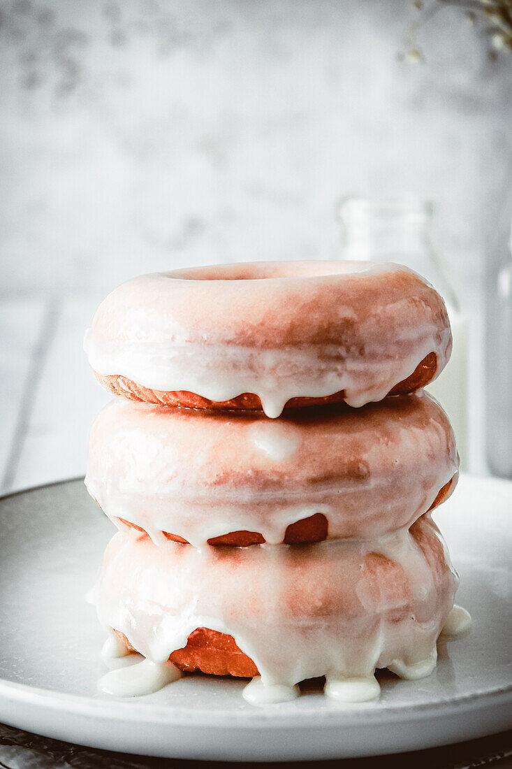 Stack of three donuts with vanilla glaze