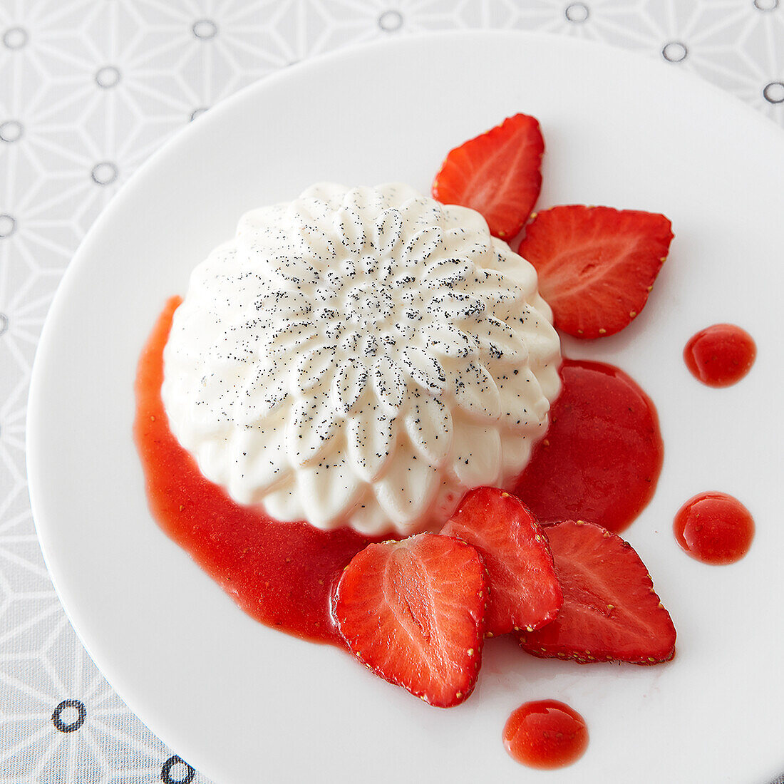 Panna cotta dome with strawberry coulis