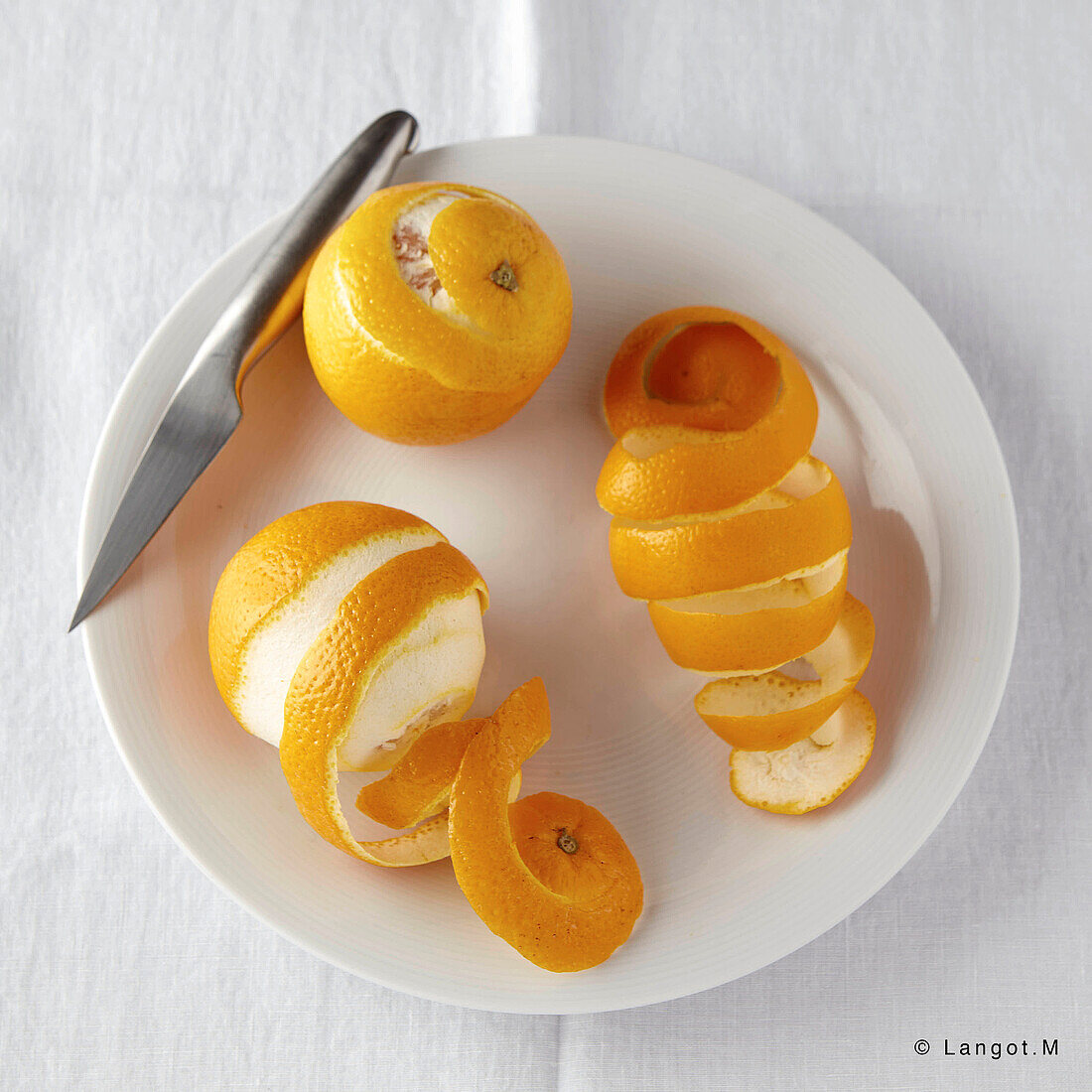 Peeling an orange making a spiral with the rind
