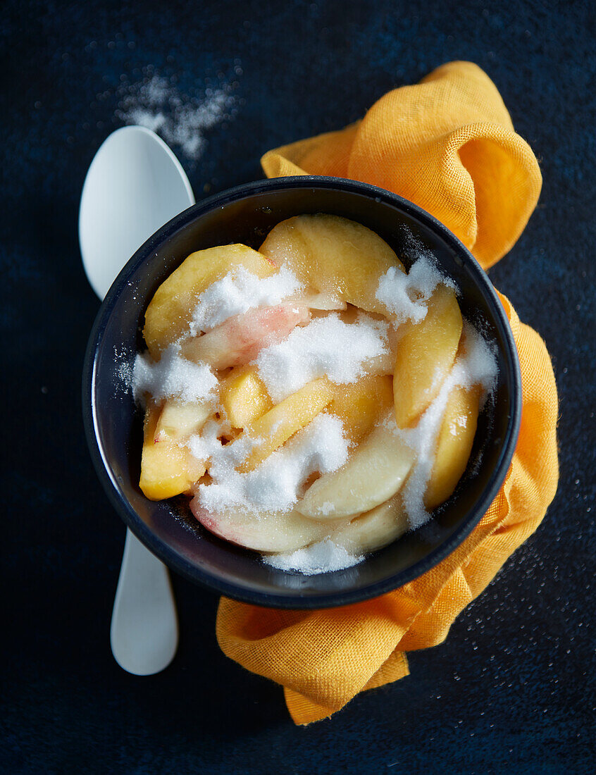 Peaches marinating in sugar