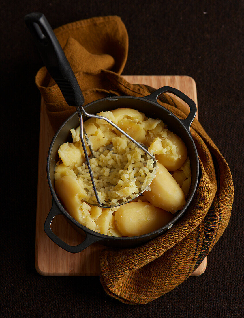 Mashing potatoes with a potato masher