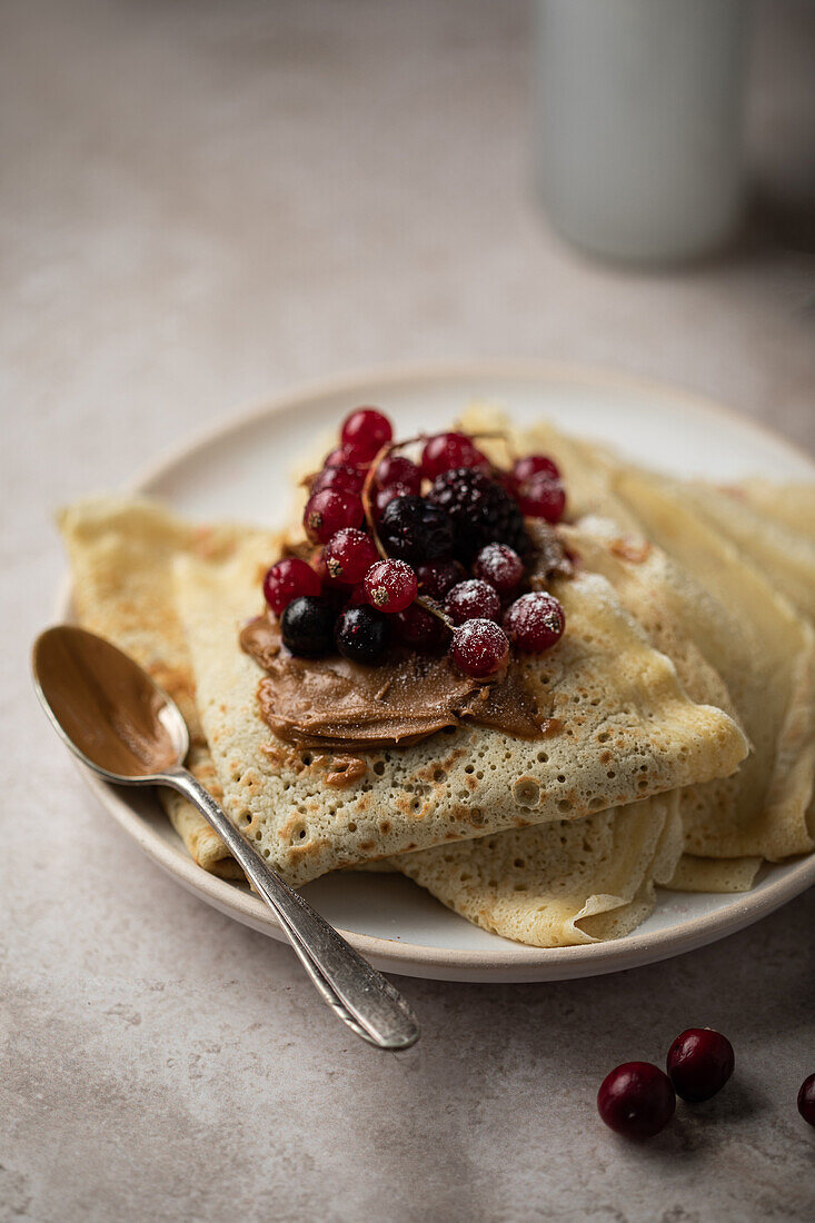 Pancakes with red fruits and hazelnut-chocolate spread