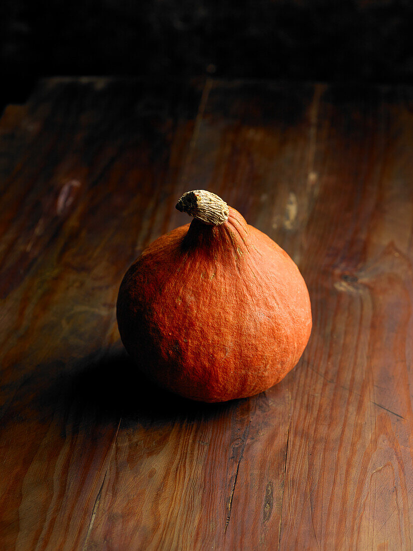 A pumpkin on a wooden background