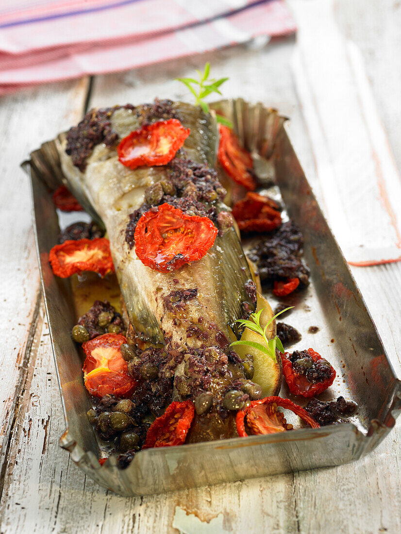 Baked fish with tapenade and tomatoes