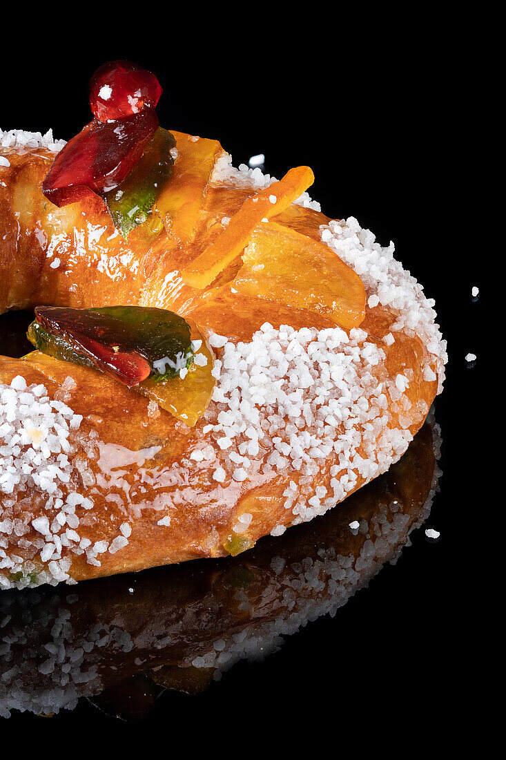 Galette des rois with candied fruit on a dark background
