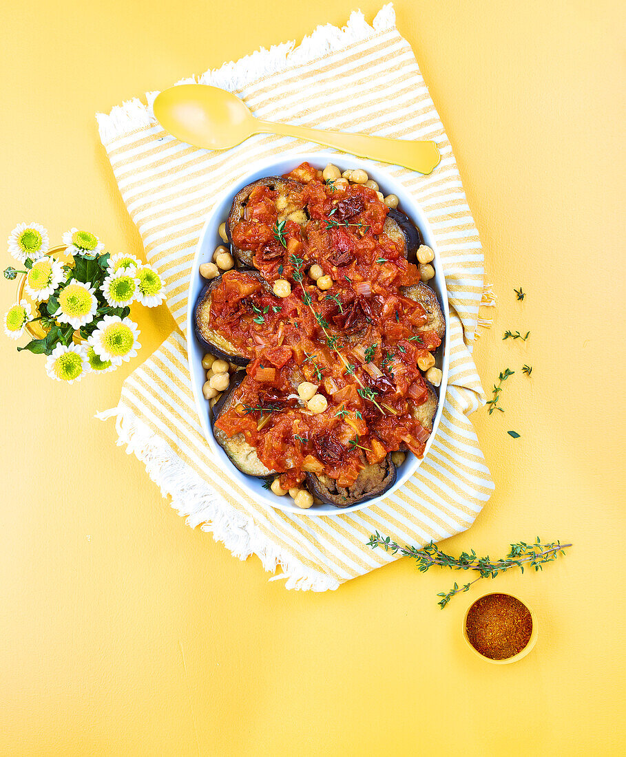 Summery moussaka with chickpeas on a light yellow background