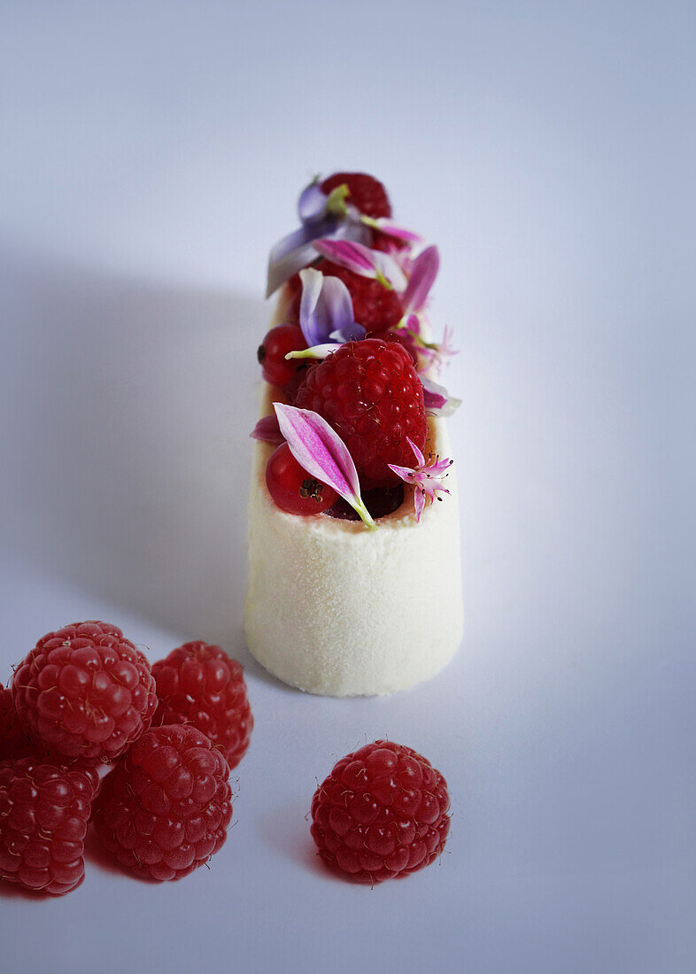 Mini cakes with raspberries and flower petals