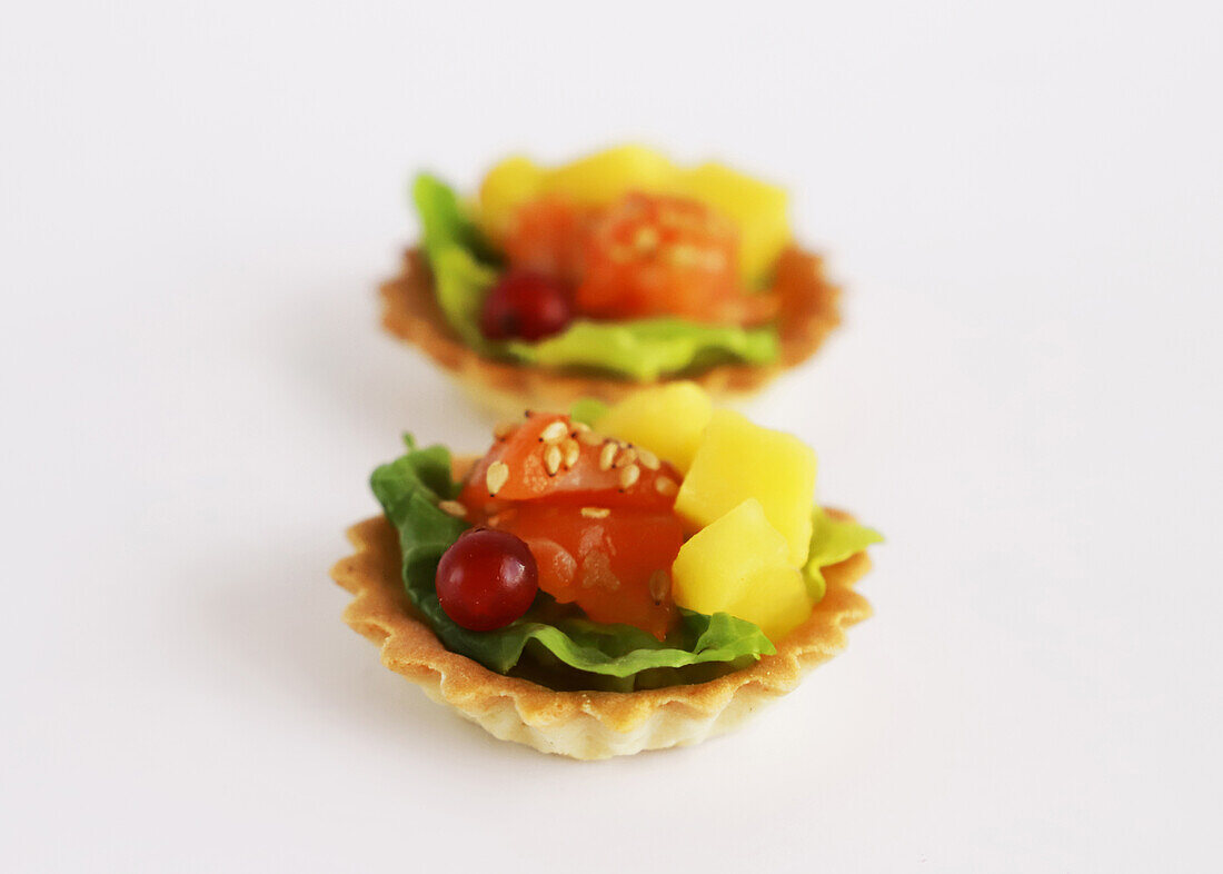 Spicy tartlets with salmon, mango and currants