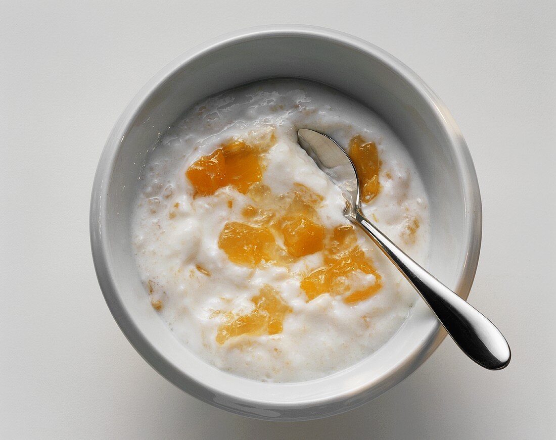 Bowl of Peach Yogurt with Spoon